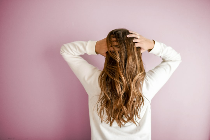 Hair in passport photos must not cover the eyes or face. Earlobes should be visible if hair falls over the ears.