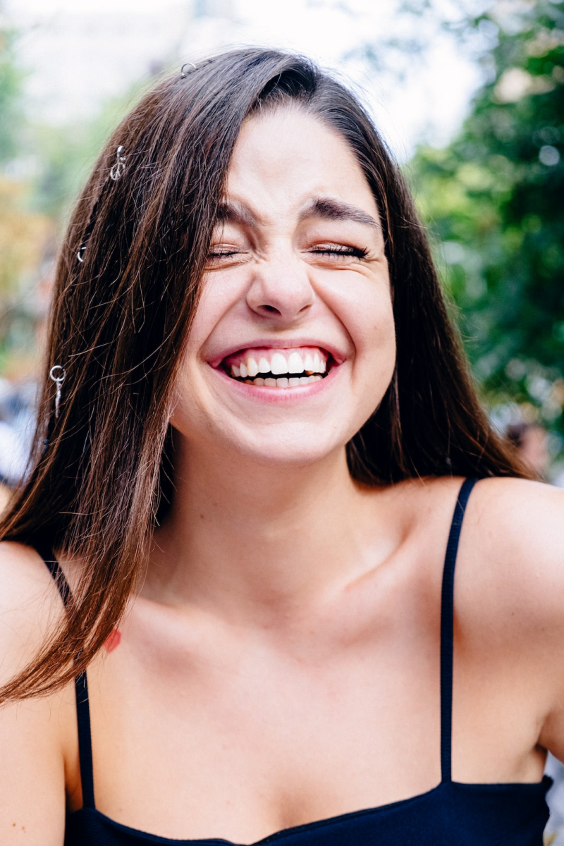 Guidelines for passport photos recommend a neutral expression, no wide smiles or open mouths. However, a slight smile may be accepted.